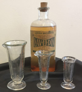Lavodin Iodine Antiseptic patent medicine with glassware.