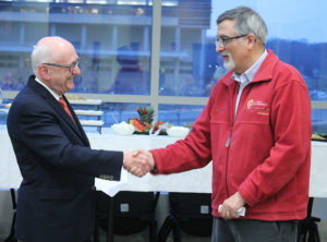 AIHP President William Zellmer shakes hands with AIHP Executive Director Gregory Higby at Higby's retirement party in 2018.
