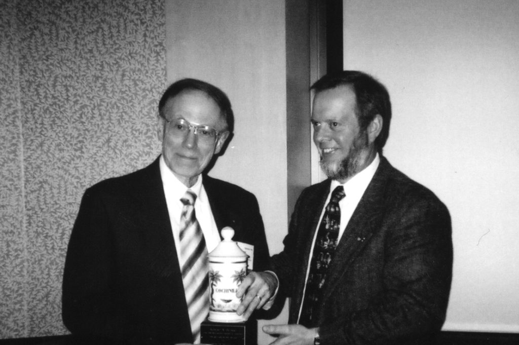 Bob Buerki (left) receives the 2004 Edward Kremers Award from W. Clarke Ridgway.